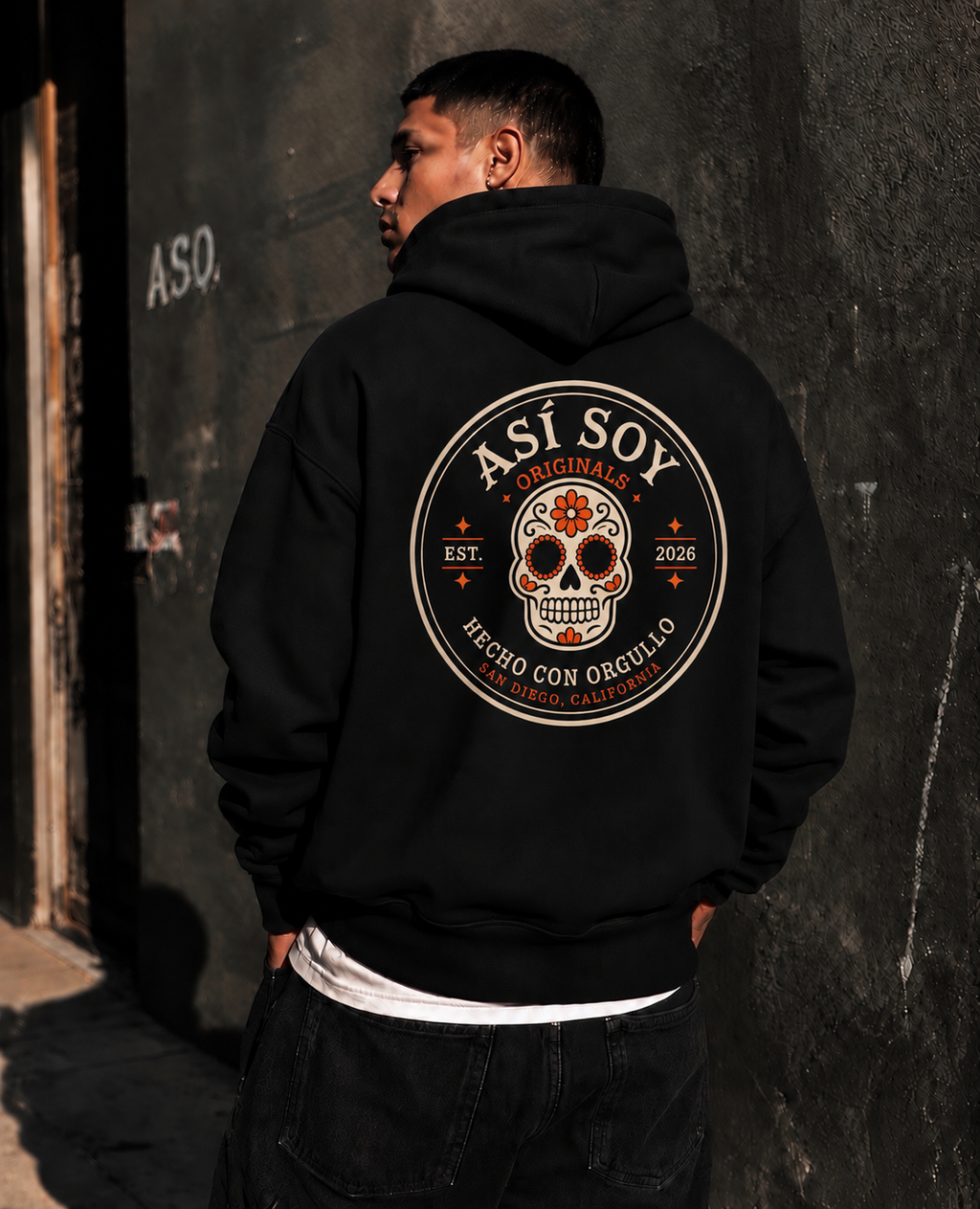 Back view of a model wearing the black ASO Signature Hoodie with a Mexican-inspired calavera graphic