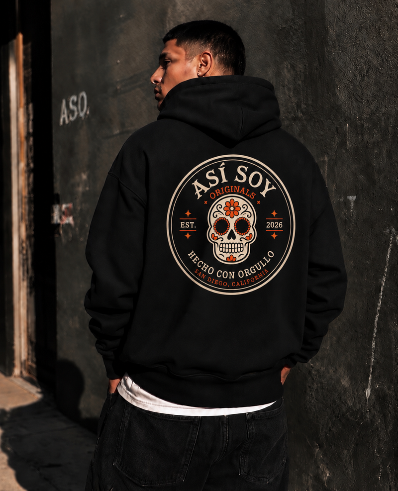 Back view of a model wearing the black ASO Signature Hoodie with a Mexican-inspired calavera graphic